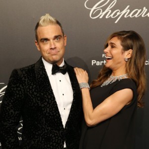 Singer Robbie Williams and his wife Ayda Field attend the Soiree Chopard 'Gold Party' on the sidelines of the 68th Cannes film festival on May 18, 2015 in Cannes, southeastern France. AFP PHOTO / JEAN CHRISTOPHE MAGNENET        (Photo credit should read JEAN CHRISTOPHE MAGNENET/AFP/Getty Images)